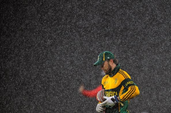 South African cricket captain AB de Villiers leaves the pitch after rain stopped play during second One Day International (ODI) match between Sri Lanka and South Africa at the R. Premadasa Stadium in Colombo on July 23, 2013. (Getty Images)